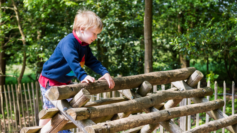 Child enjoying the Badger and Pepper play area at Scotney Castle, Kent